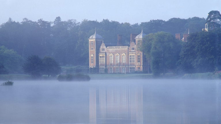 Blickling Hall and lake on a misty morning